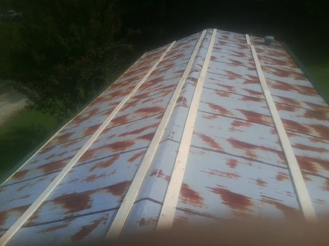 Rusted metal roof panels with new wood purlins before replacement — Storm Damage Roof Repair in Mineral Wells by Roofing Brothers